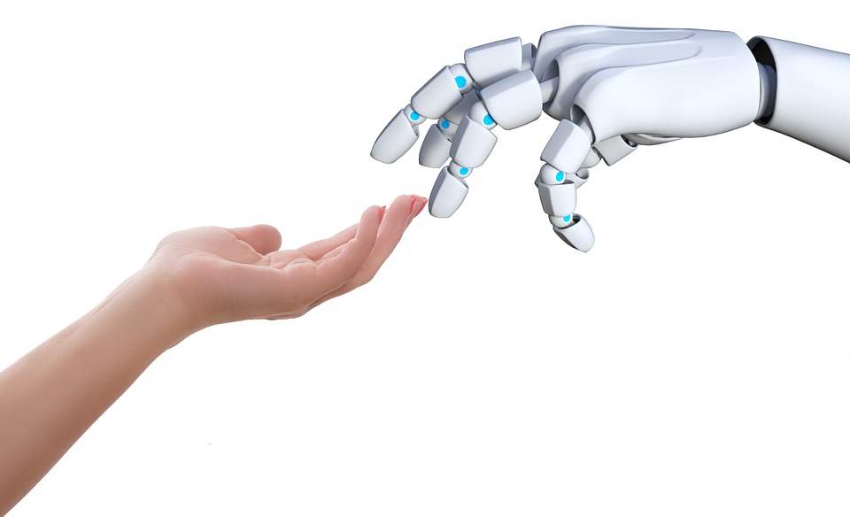 Human hand touching a robot hand