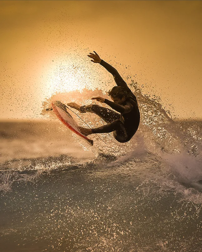 Man on a surfboard riding waves in the sea