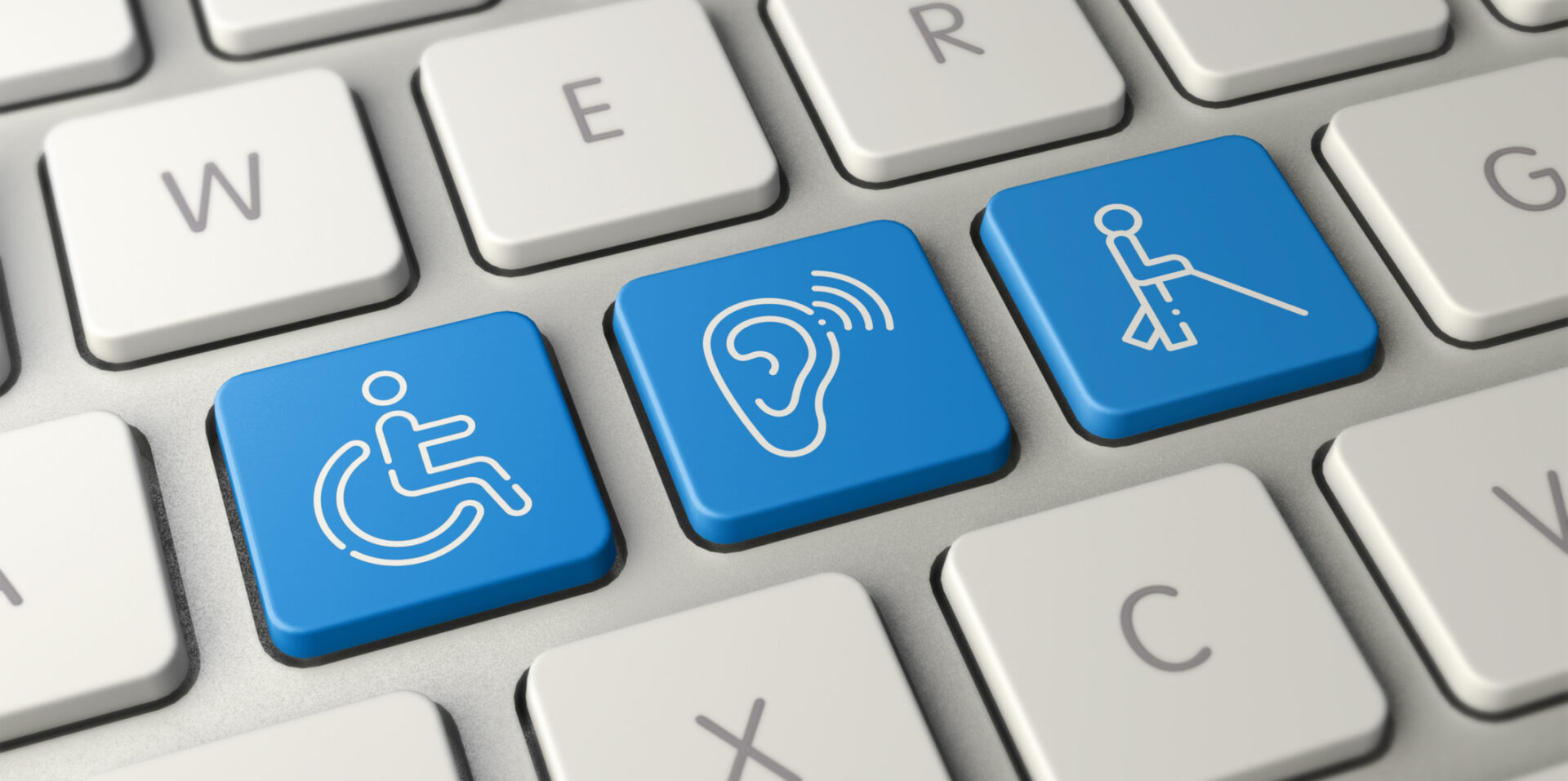 Laptop keyboard with keys replaced to show a wheelchair symbol, hearing loss symbol and a blind person symbol.