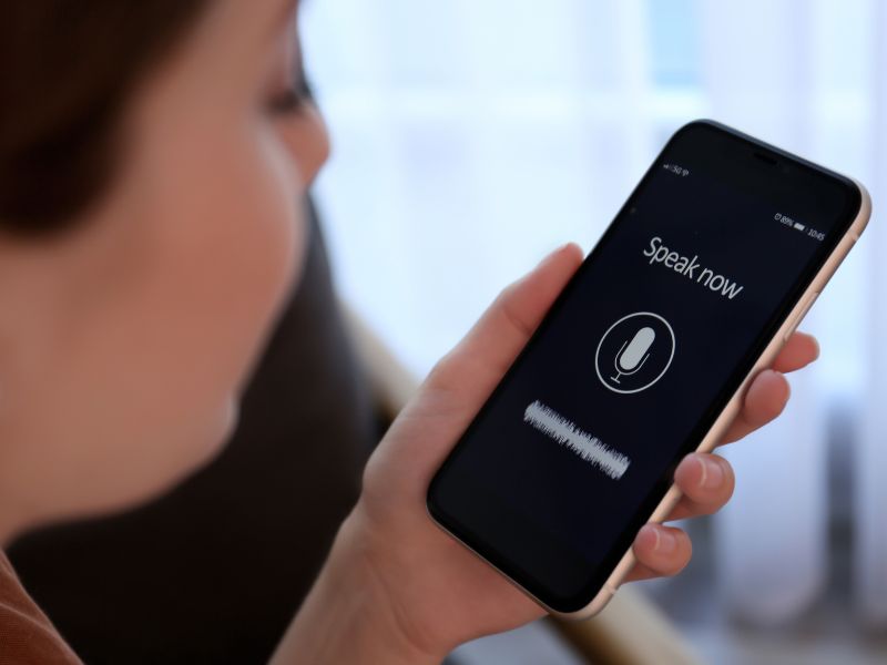 A woman using voice search on her phone