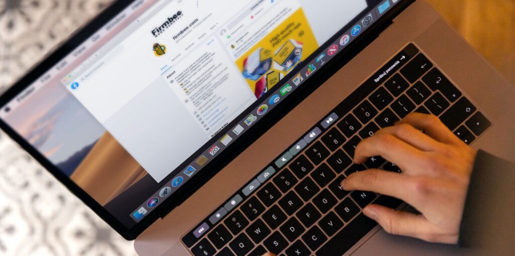 person on laptop managing facebook page