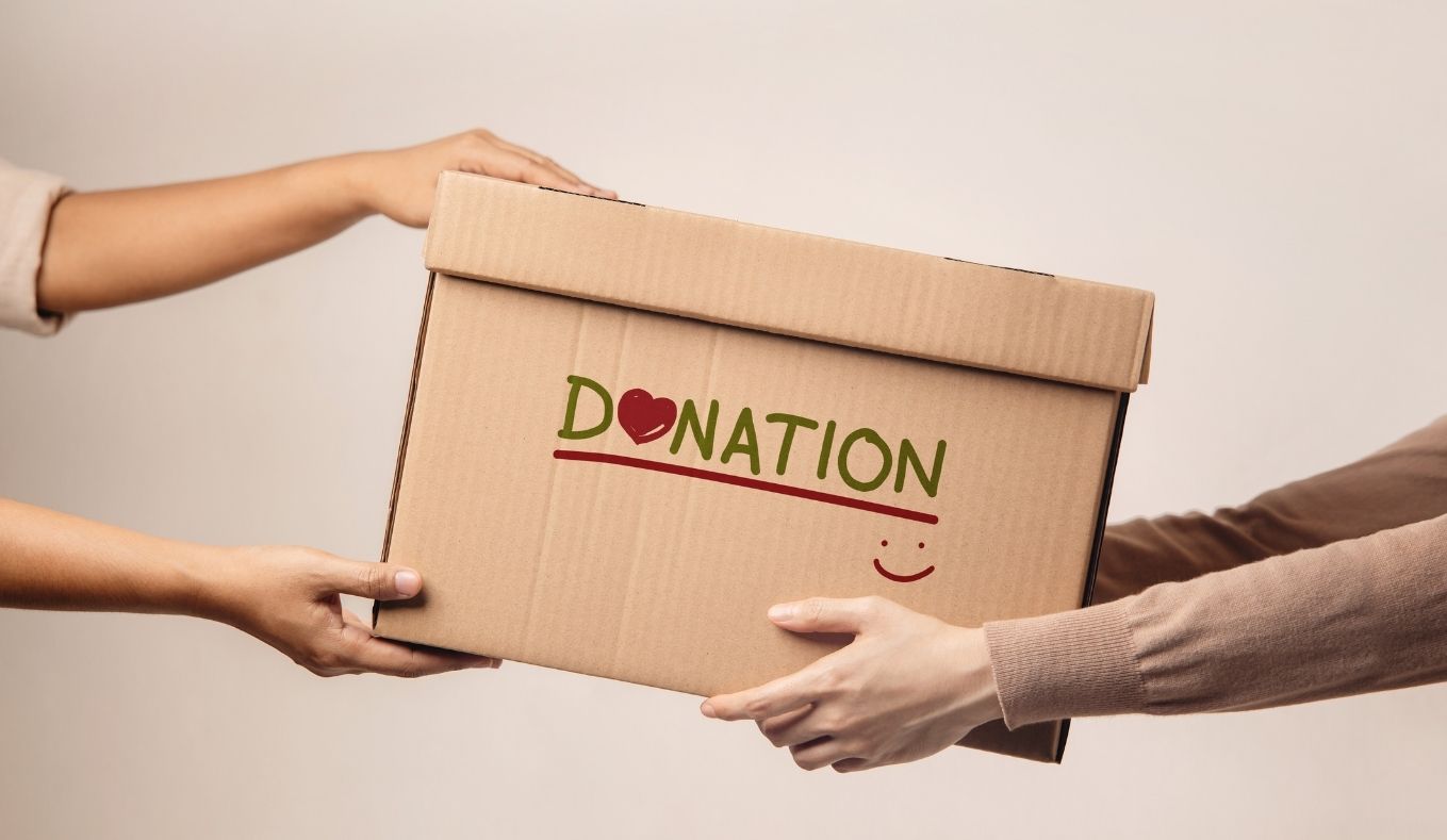 two people holding a donation box