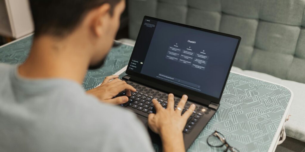 man using chatgpt on laptop
