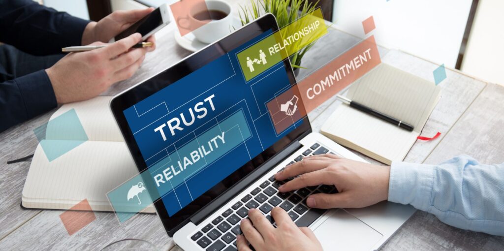 laptop showing trust concept on website with trust, reliability, relationship and commitment words
